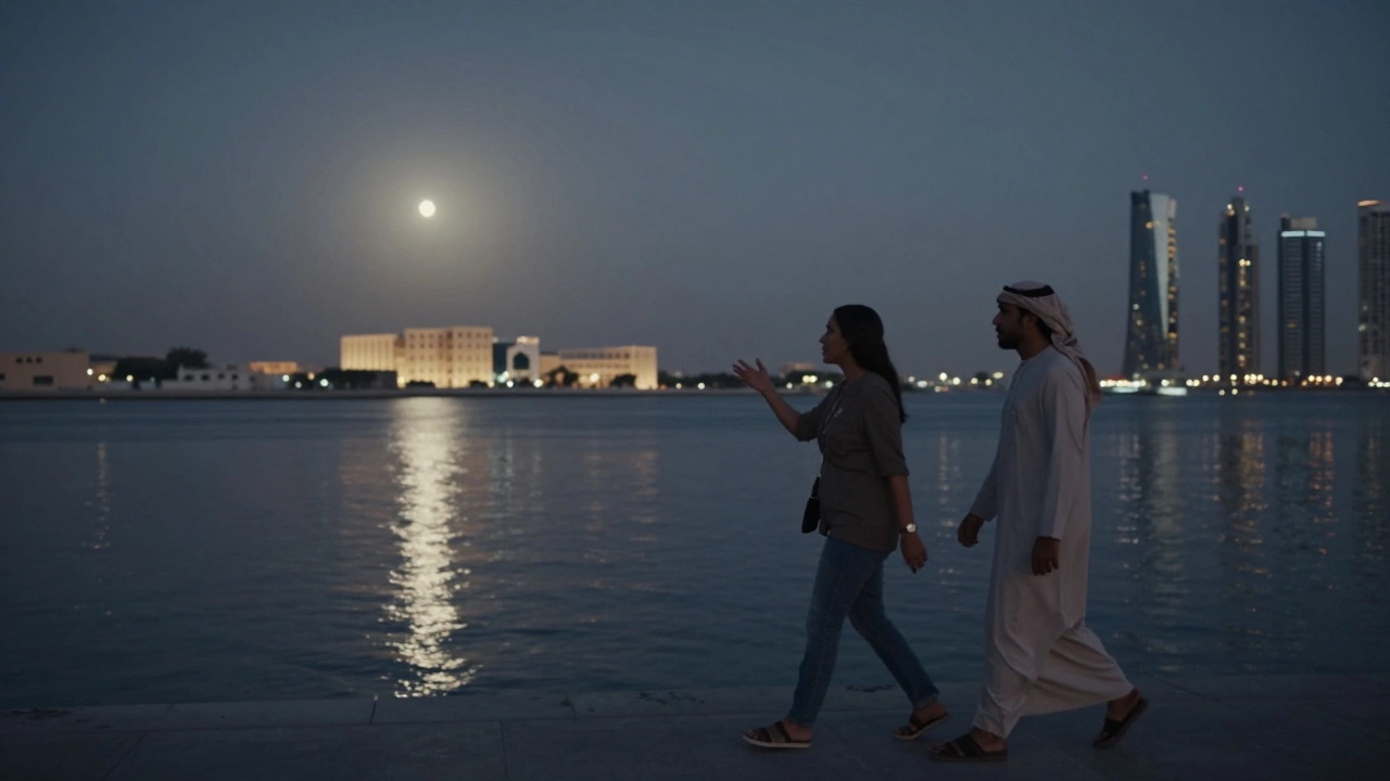 Two people walking peacefully along Dubai Creek at night under moonlight.